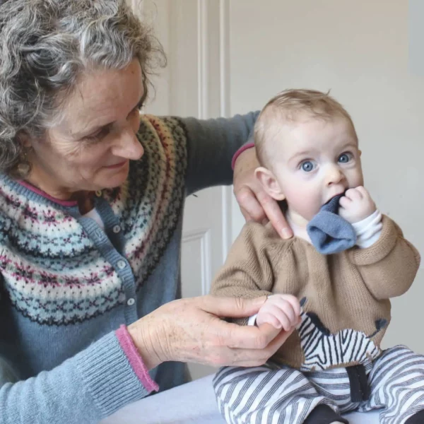 Jeni Briggs, founder of The Courtyard Osteopaths in Bristol, gently assessing a baby's shoulder