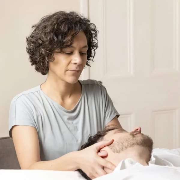 Colette Tirimo, osteopath at The Courtyard Osteopaths in Bristol, using gentle cranial techniques with a patient